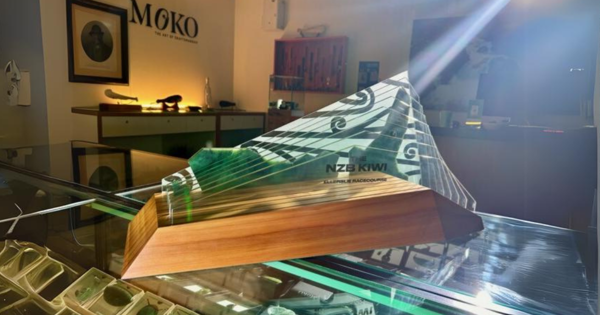 A trophy is sitting on top of a glass table in a room.