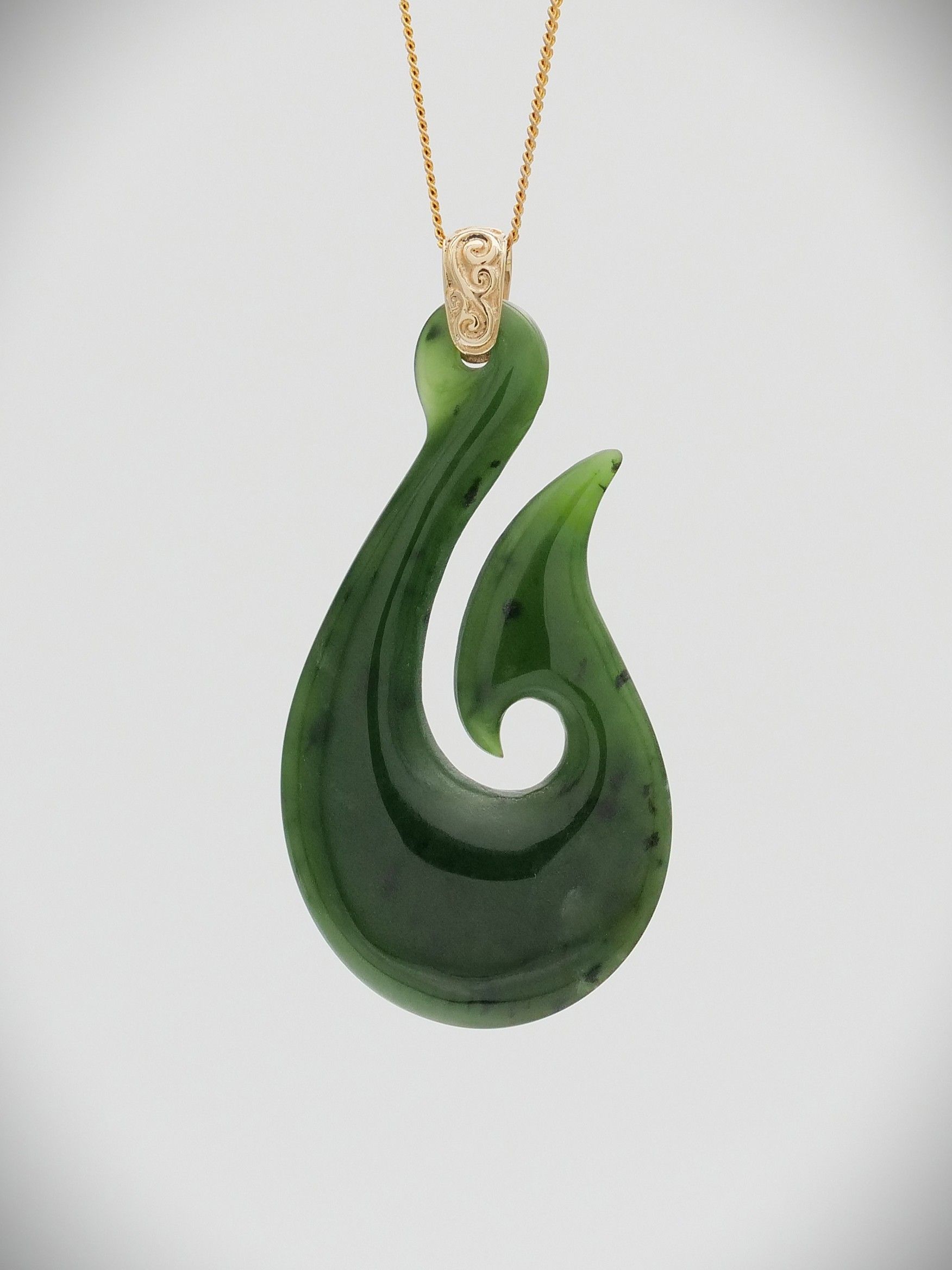 hei matau greenstone and gold pendant
