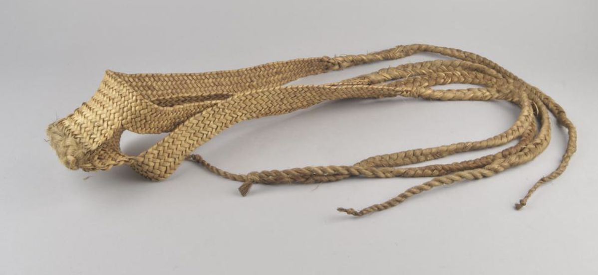 A close up of a rope on a white surface.