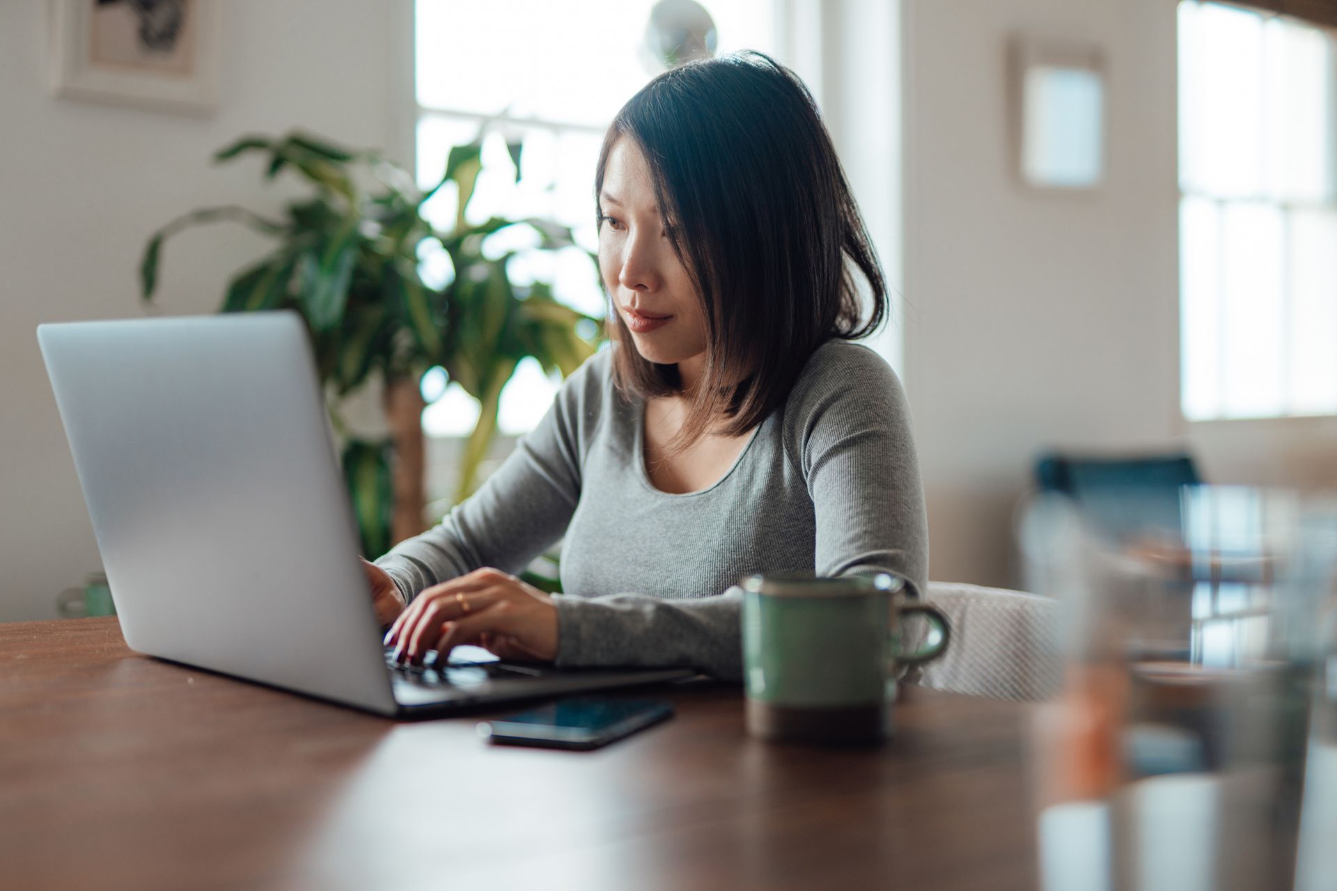 Young Asian woman working from home with laptop Young Asian woman working from home with laptop