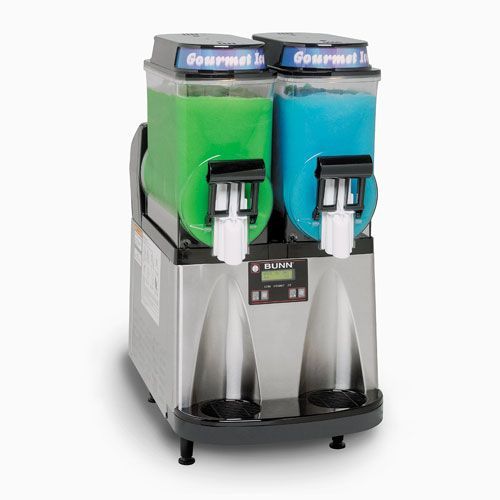 Dual-tank slushy machine with green and blue frozen drinks. Silver base, black spouts, and