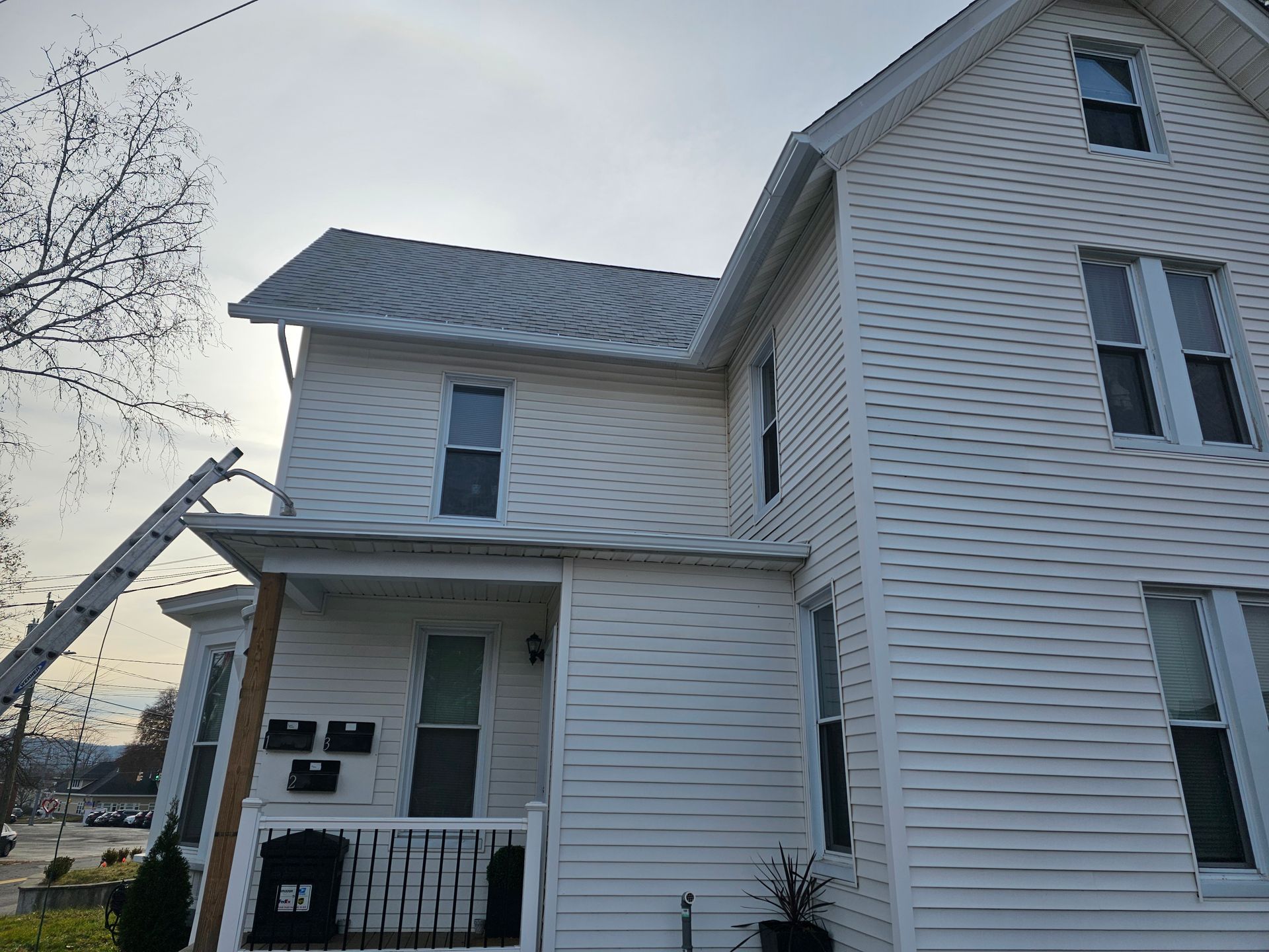 A close up of a white gutter on the side of a house.