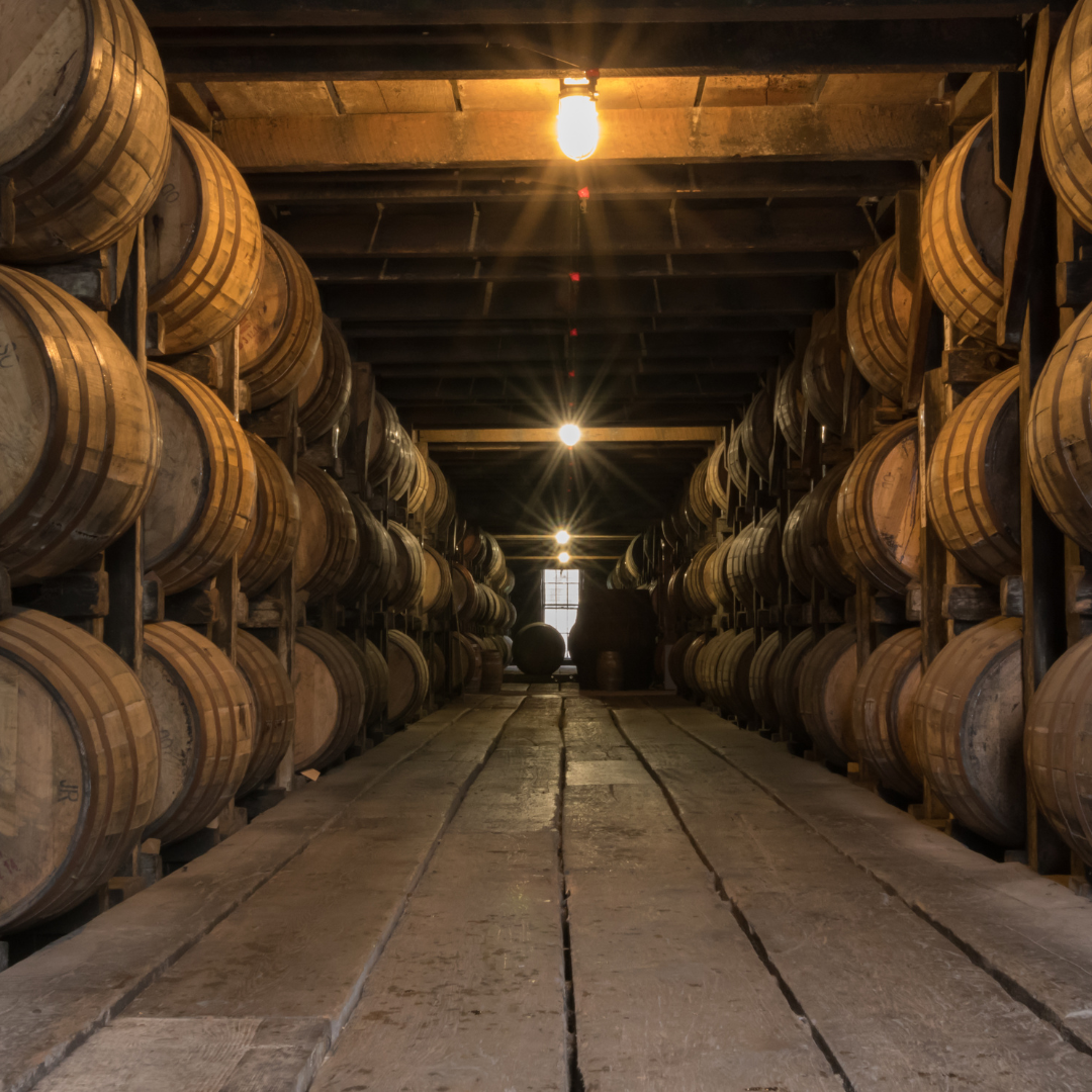 A warehouse filled with lots of wooden barrels
