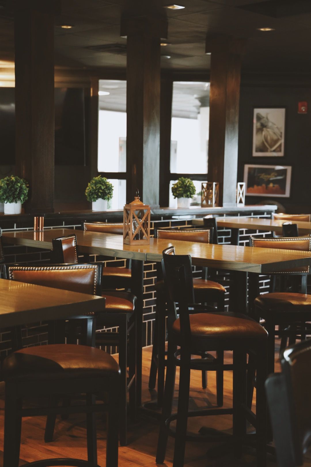 A restaurant with tables and chairs and a clock on the table