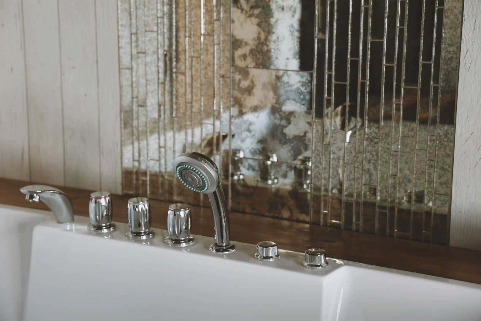 A bathtub with a shower head and faucet in a bathroom.