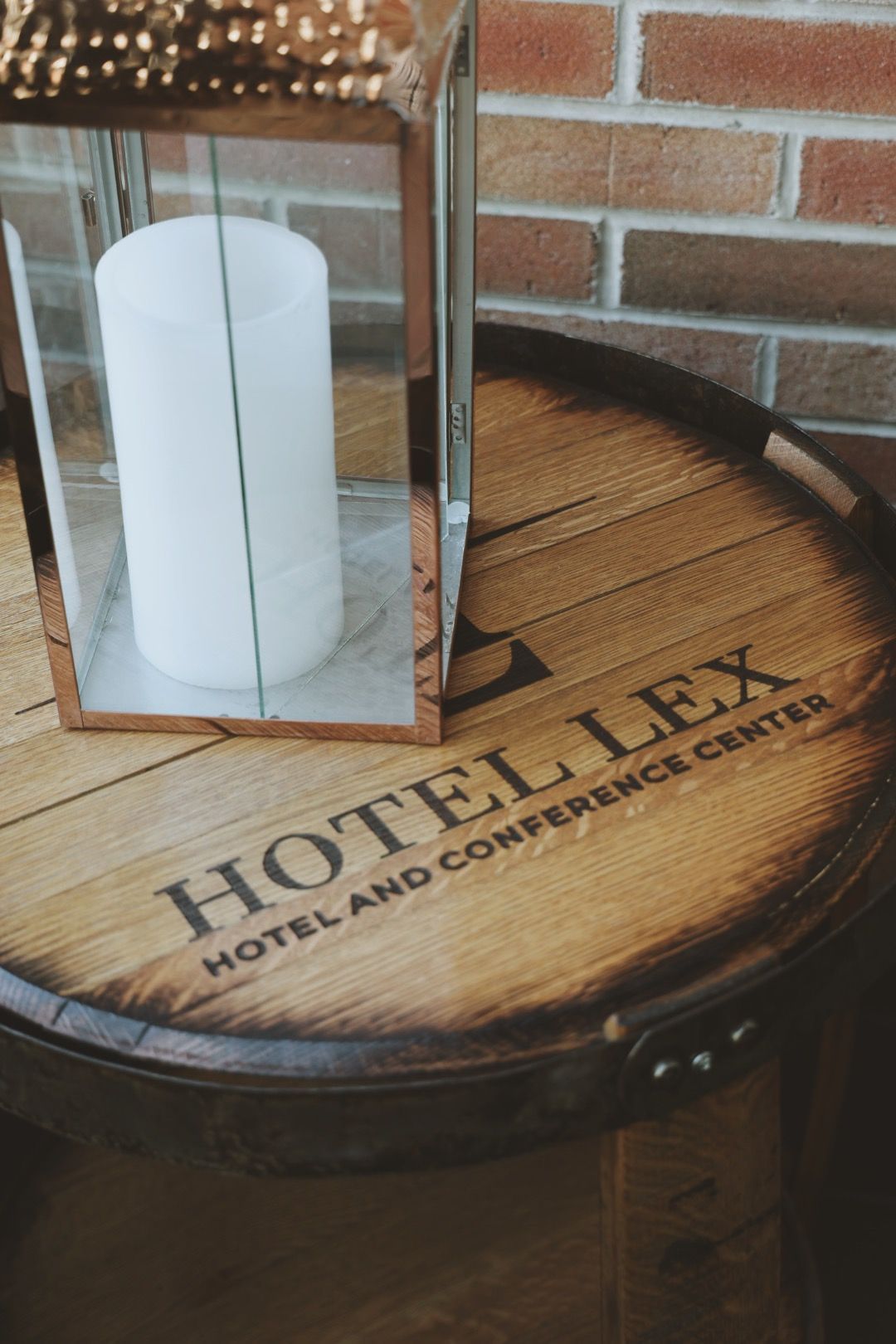 A candle is sitting on top of a wooden barrel.