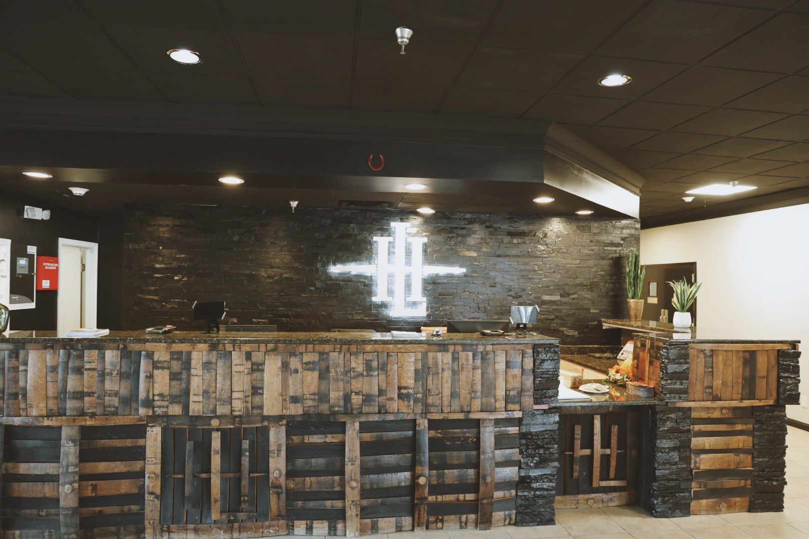 A restaurant with a wooden bar and a sign on the wall.
