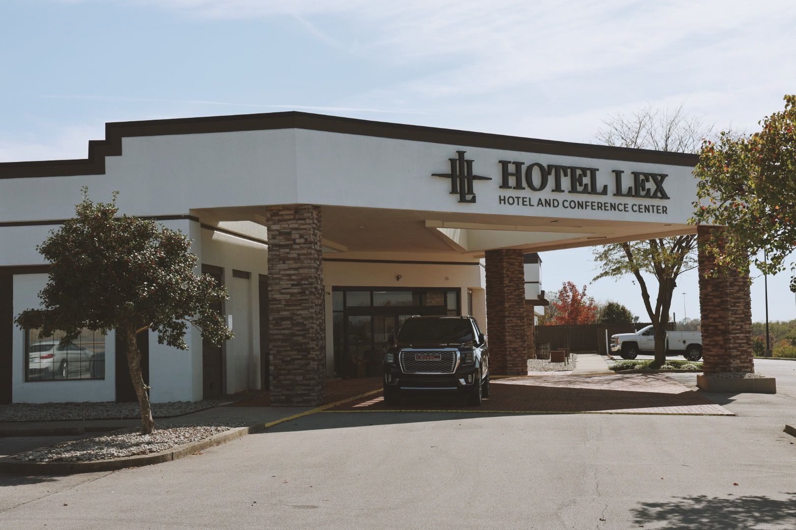 A car is parked in front of the hotel lex