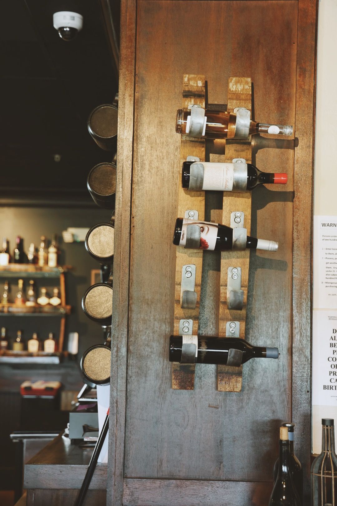 A wooden wine rack with bottles of wine on it