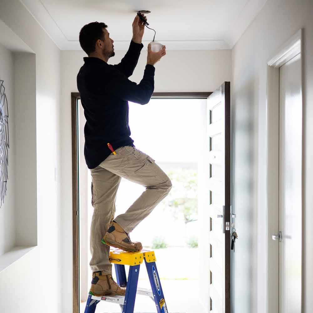 Worker Fixing Lights — Level 2 Electrician in Toukley, NSW