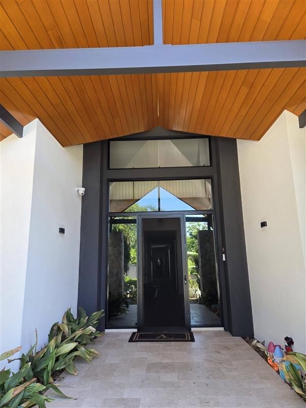 A Hallway With a Wooden Door and a Glass Door — Eva Professional Painting in Robina, QLD