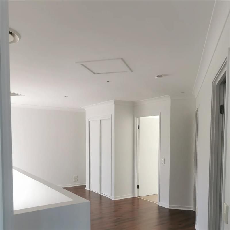 A Living Room With Sliding Glass Doors and a Ceiling Fan — Eva Professional Painting in Robina, QLD