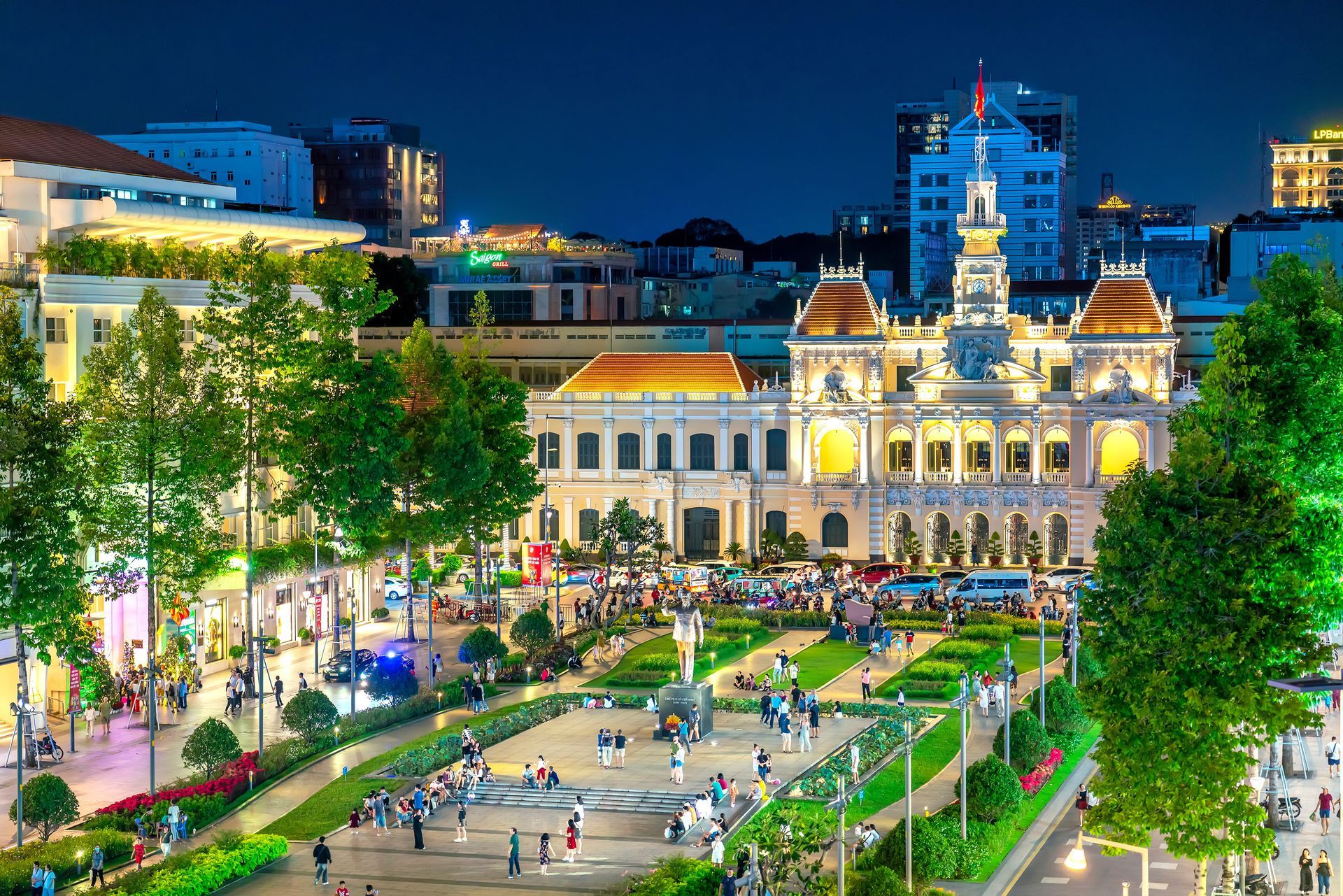 A panoramic cityscape in front of the iconic People's Committee Building, located in the vibrant heart of downtown Saigon.