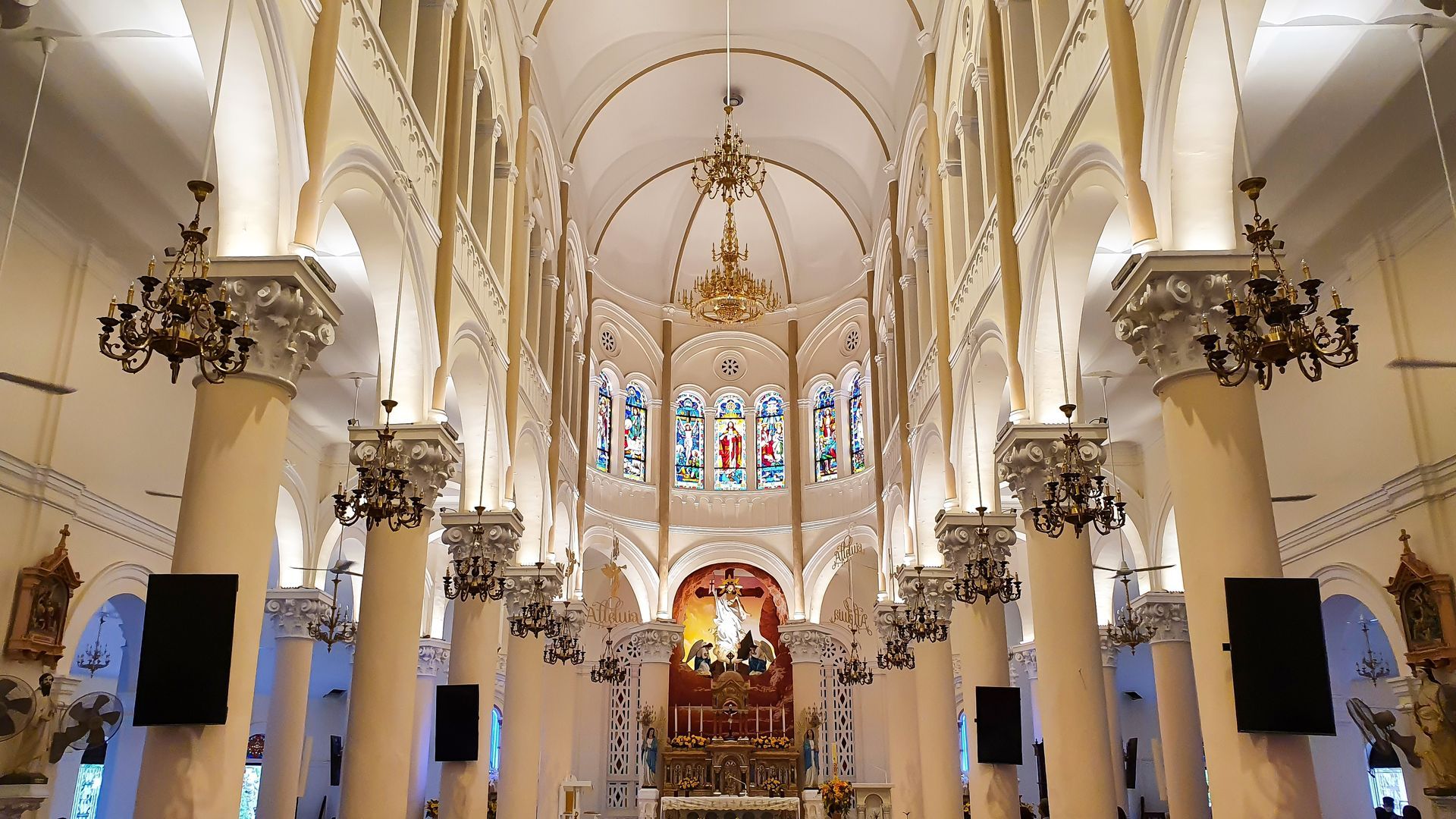 Inside Tan Dinh Church, you can see a the playful theme with cream-colored pillars and arches, a beautifully lit central nave.