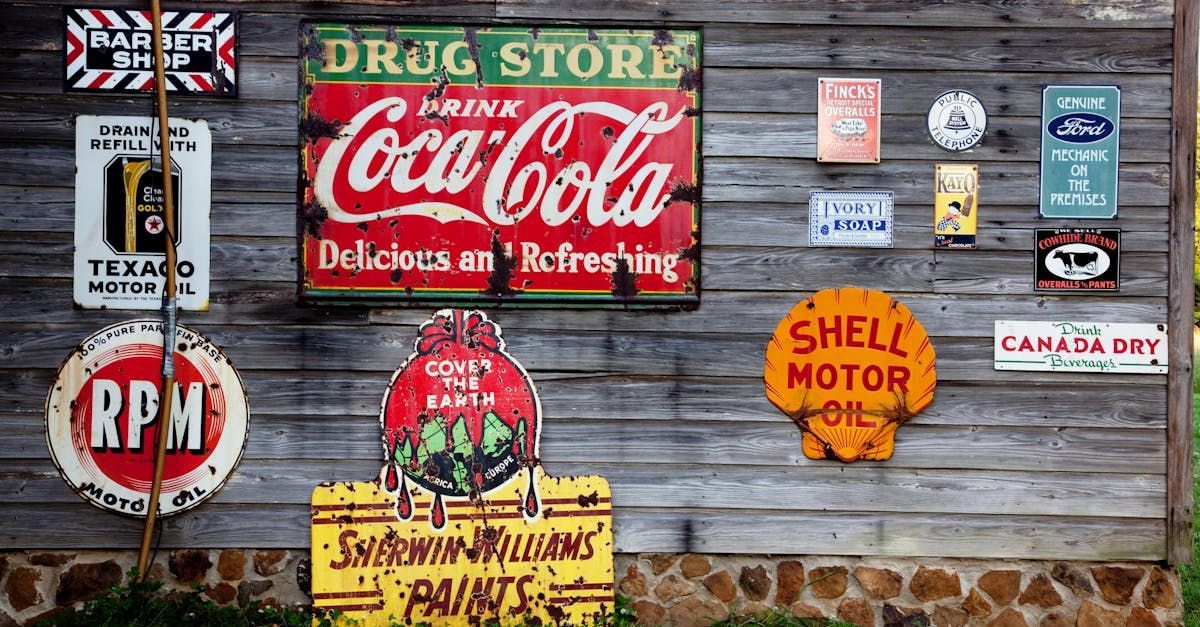 A coca cola sign hangs on a wooden wall