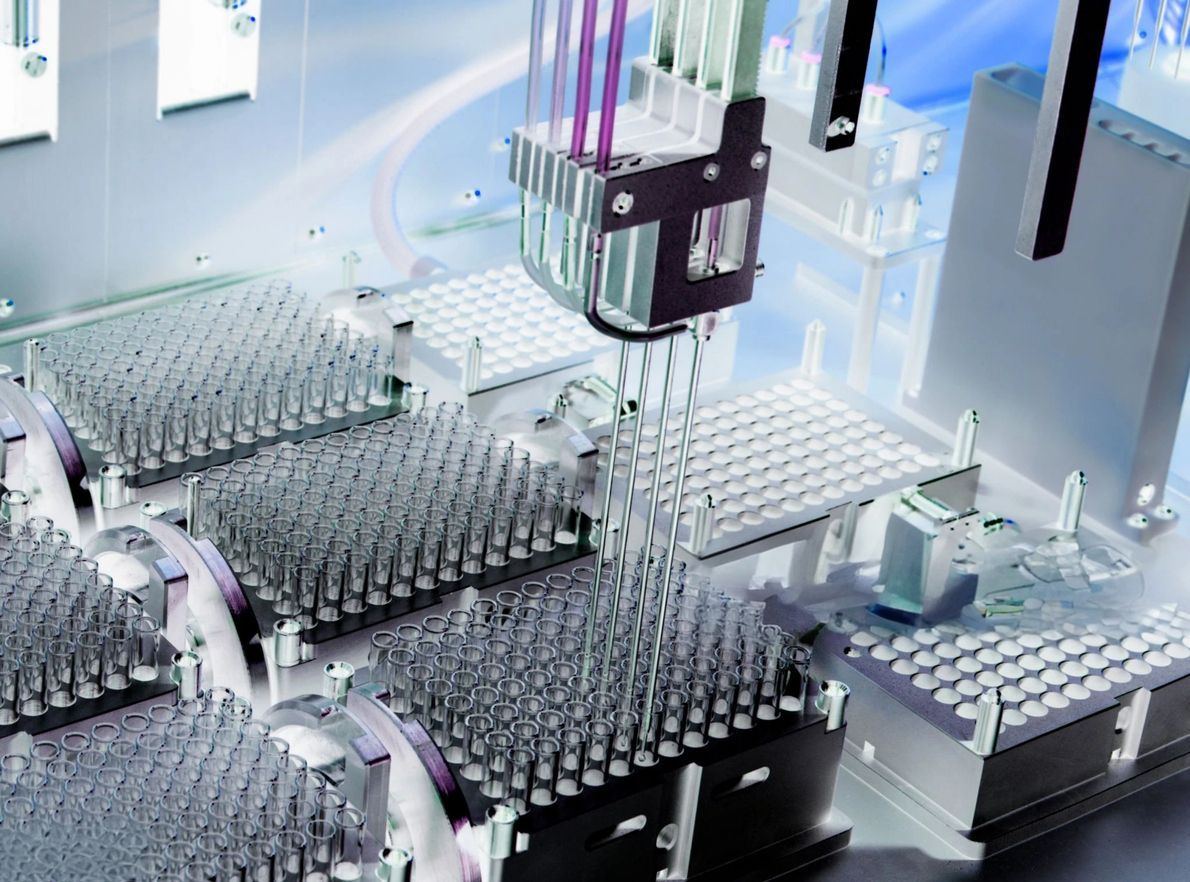 Close-up of metallic industrial machinery with multiple cylinders and complex gears.