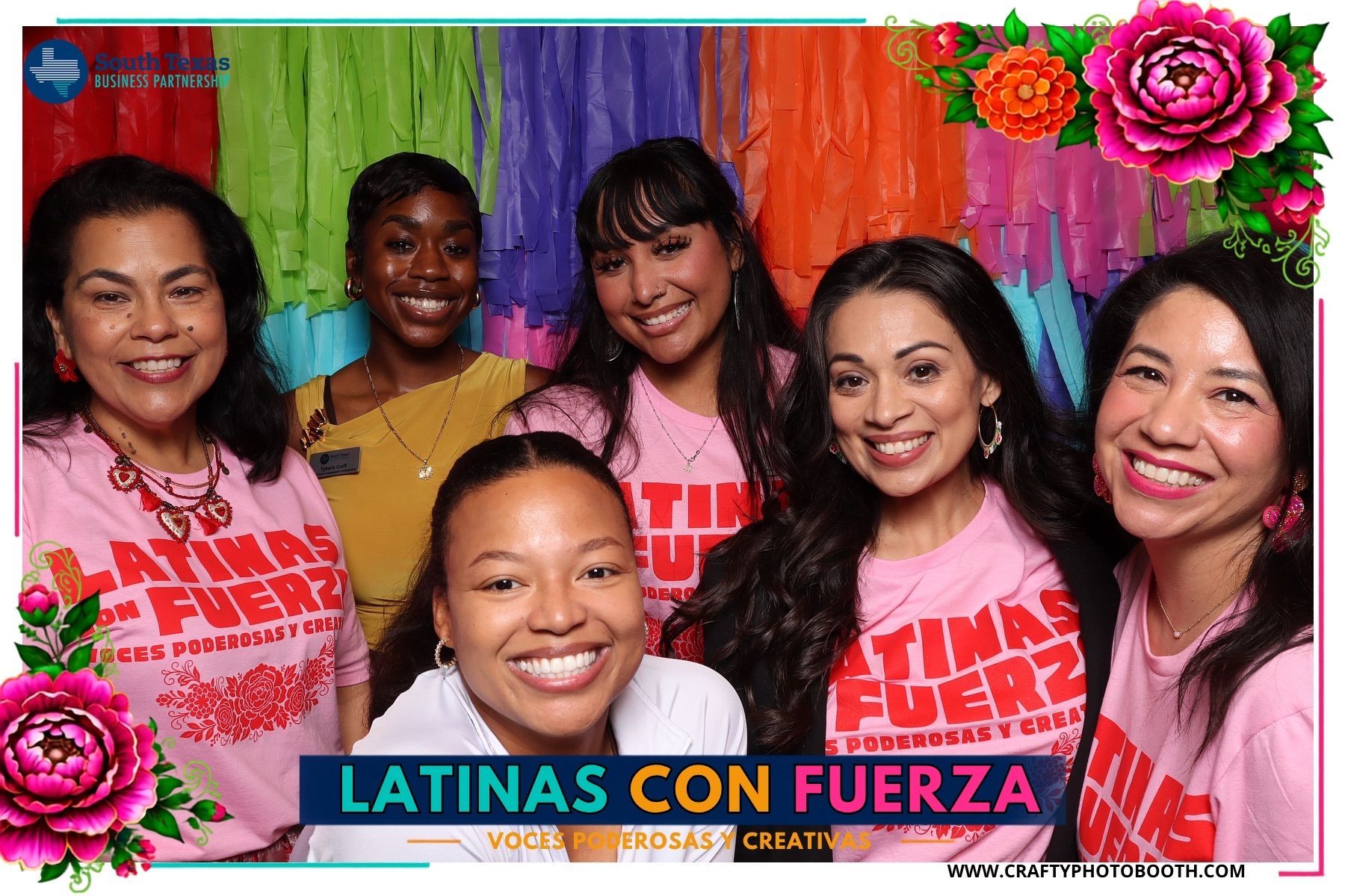 Printed photo booth portrait in front of the colorful Latinas con Fuerza event backdrop