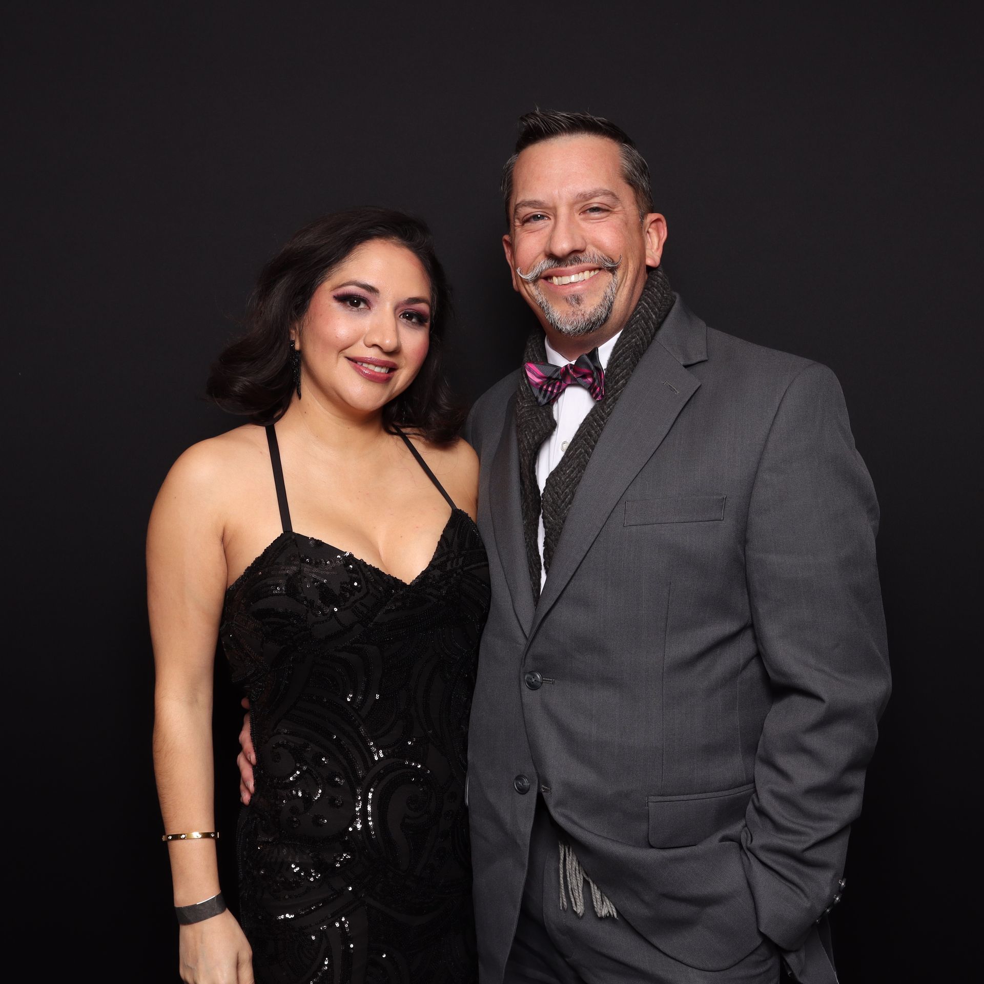 San Antonio party guests posing in open-air printed photo booth setup