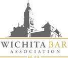 A logo for the wichita bar association with a clock tower in the background.
