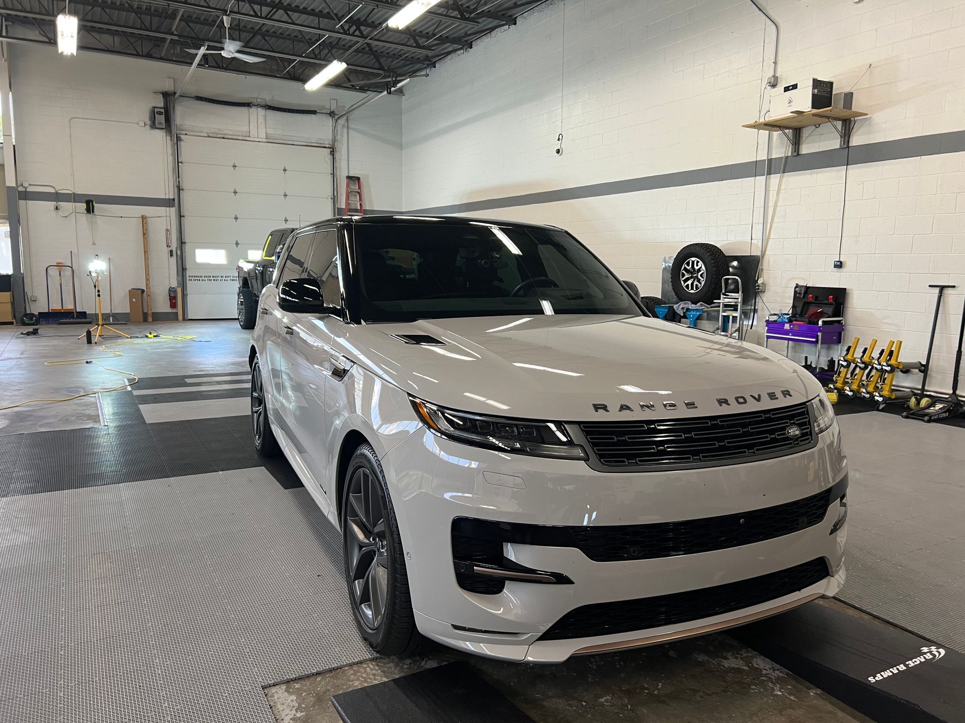 White Range Rover Sport in a garage.