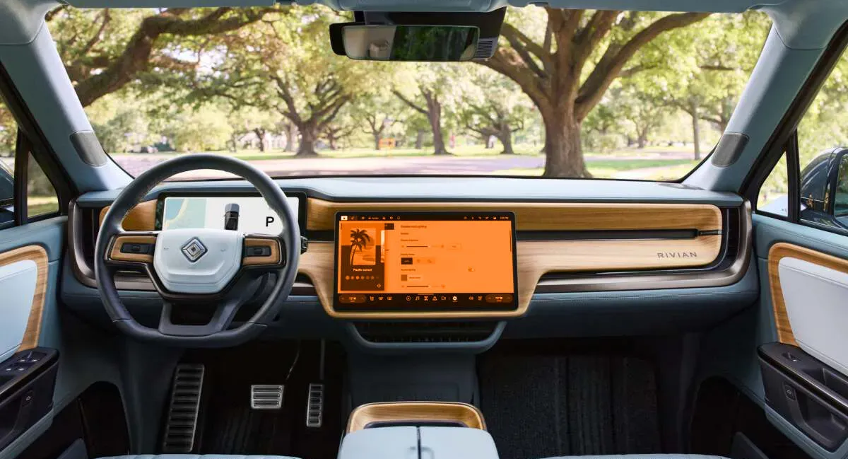 The interior of a car with a large screen on the dashboard.