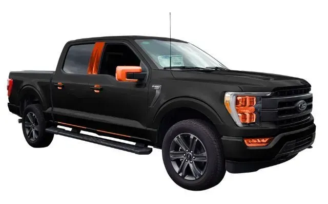 A black ford f150 pickup truck with orange trim on the doors and fenders on a white background.