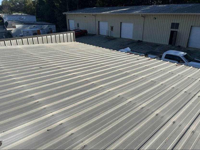 Metal roof on a commercial building; gray corrugated sheets.
