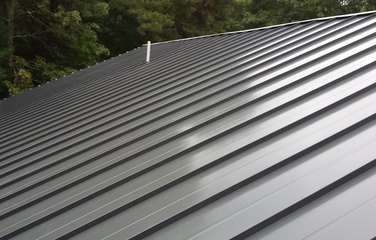 Metal roof with gray panels reflecting light.