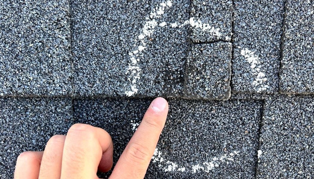 Chalk circled hail impacts on an asphalt shingle roof, documented during a Roofing Georgia inspection in North Georgia