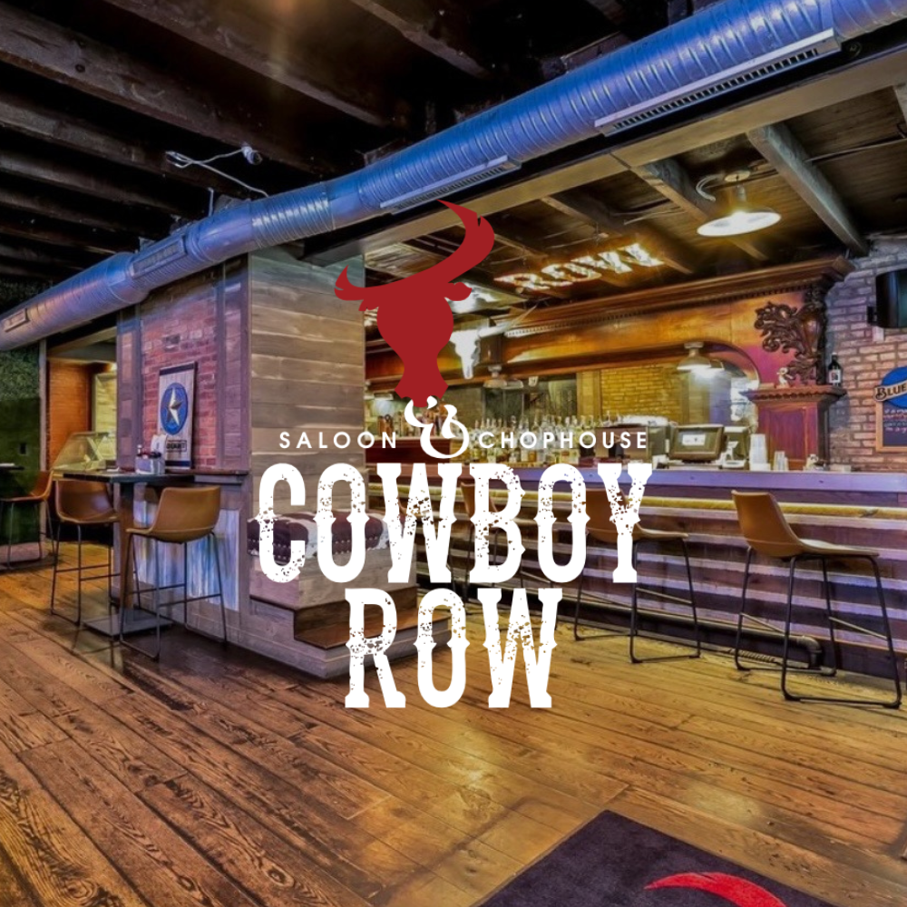 Cowboy Row Saloon and chophouse interior with rustic wooden decor and large “COWBOY ROW” sign on the wall and log on top of image