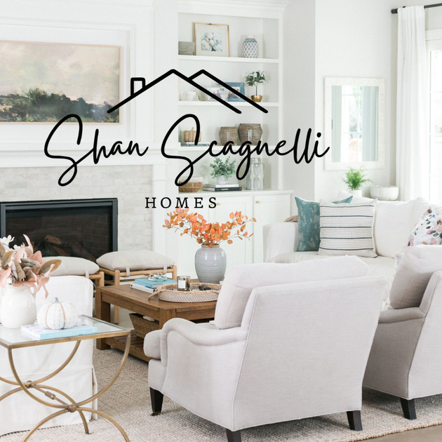 Shan Scagnelli Homes logo in black on top of a staged living room showcase