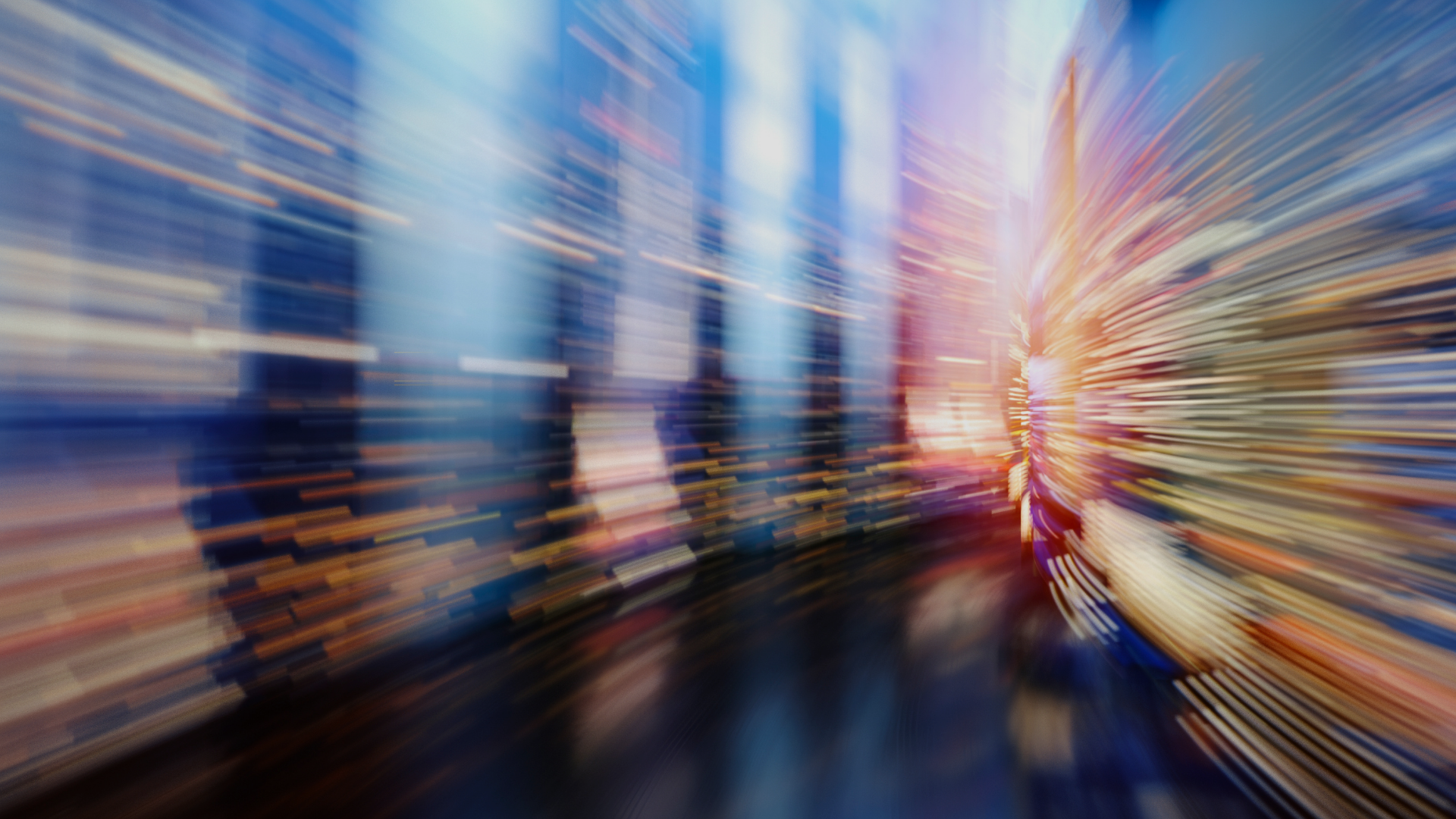 Abstract motion-blur city street with bright light streaks and a person walking