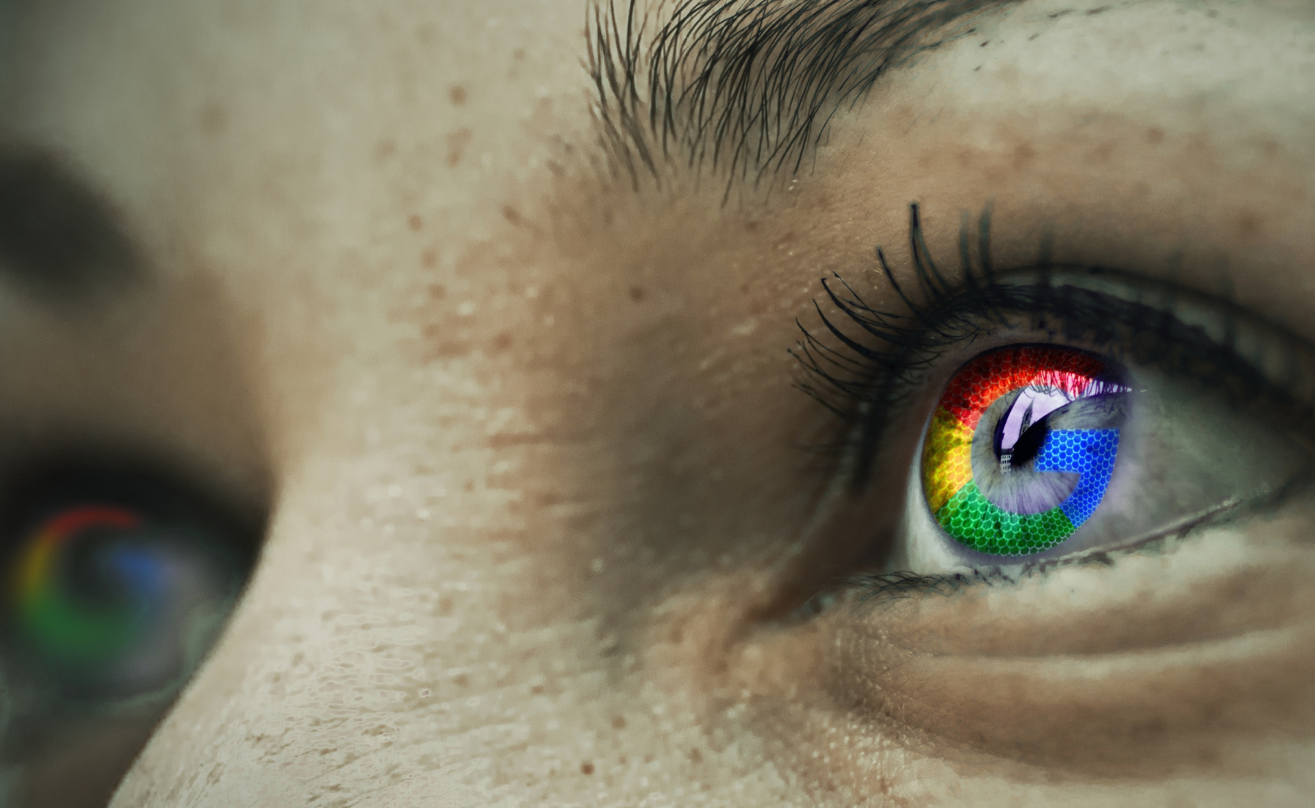 Close-up of a person’s eye with a colorful Google icon reflection in the pupils