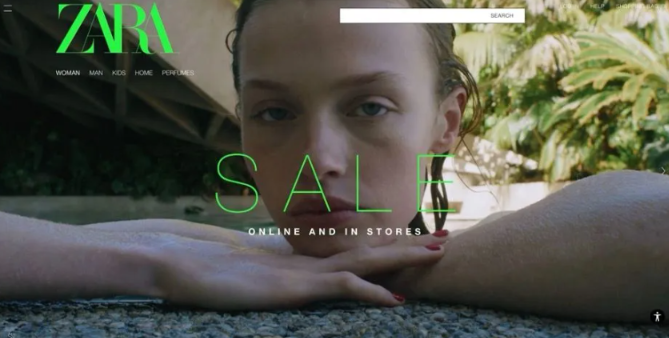 Fashion website banner with a person resting on a stone ledge, green “SALE” text over a tropical background.