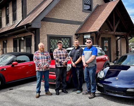 the hood of a car is open in a garage .