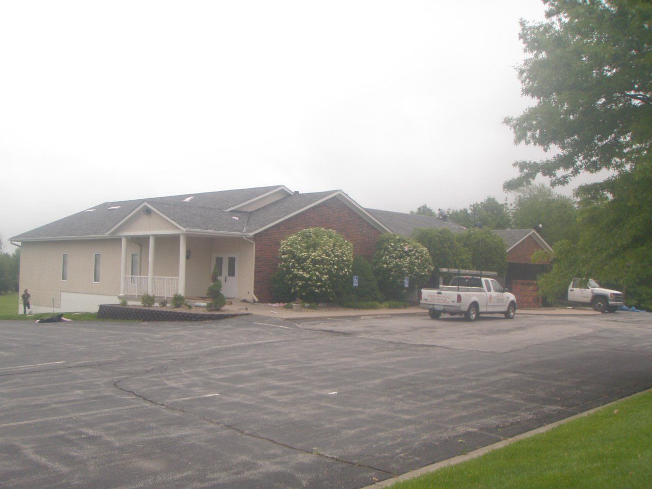 A white truck is parked in front of a house