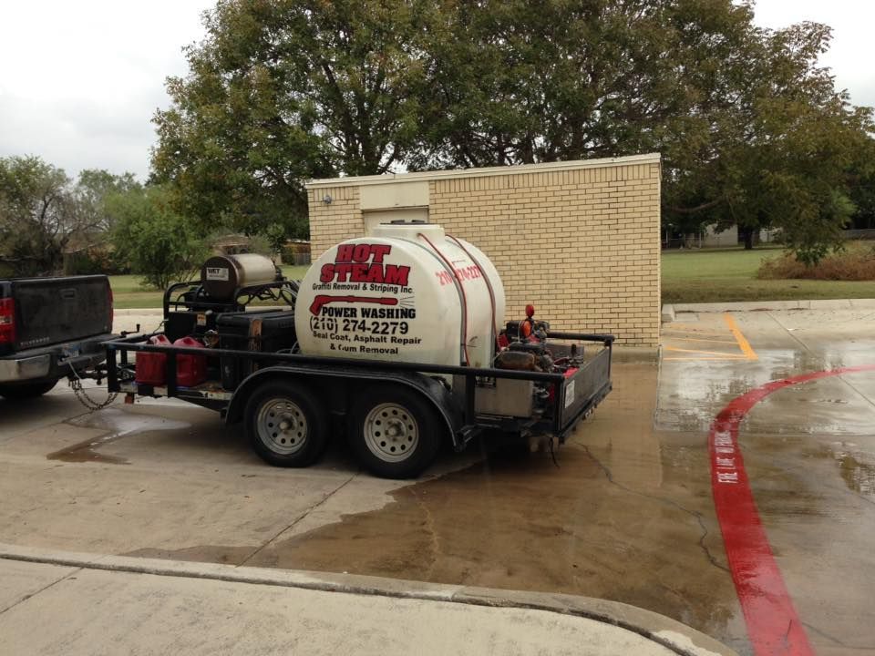 A jet washing trailer is parked in a parking lot