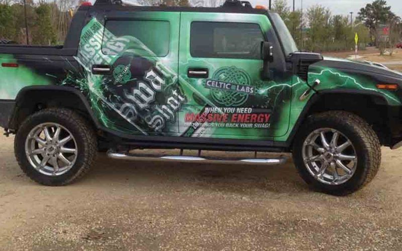 Hummer truck wrapped in green graphics, promoting 