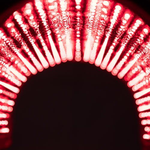 Red, arched light beams against black background.