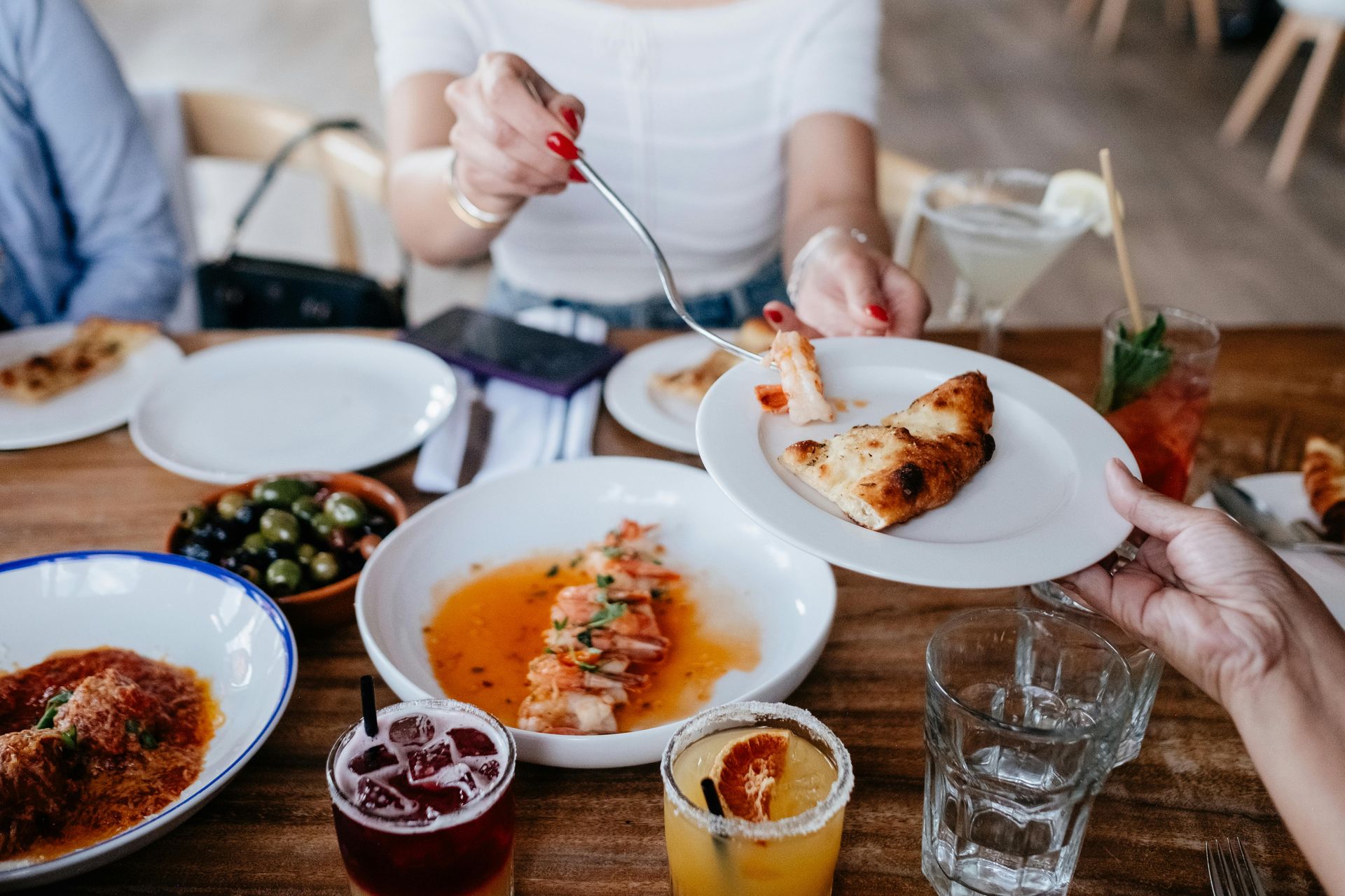 Food served on white plates with dark wood table below