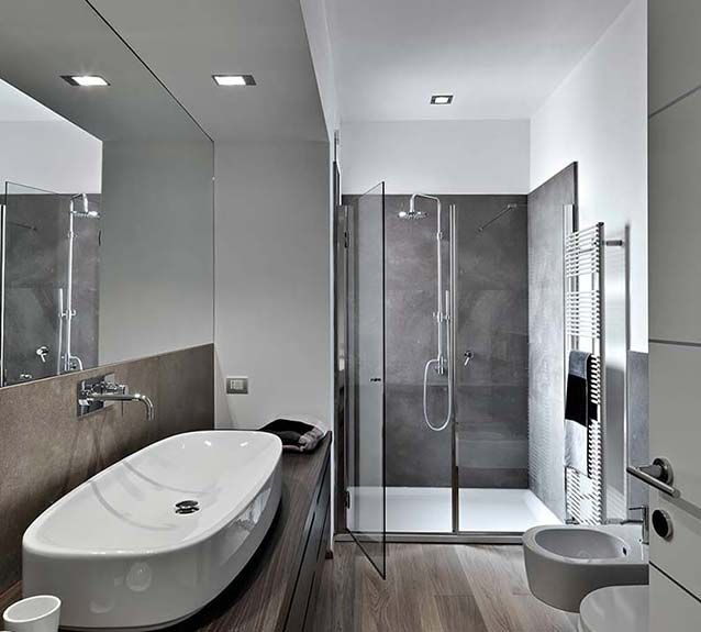 A bathroom with a sink , toilet , shower and mirror