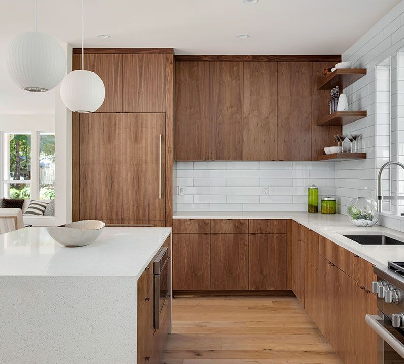 A kitchen with wooden cabinets and a white counter top
