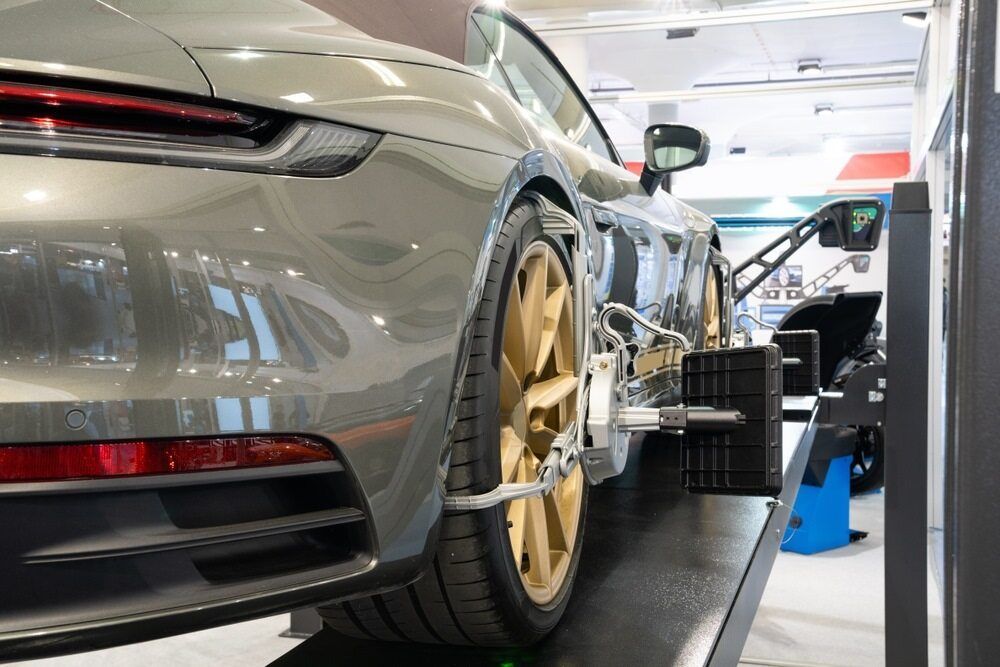 A Car is Being Adjusted by a Machine in a Garage — Cars to Cabs In Wickham, NSW