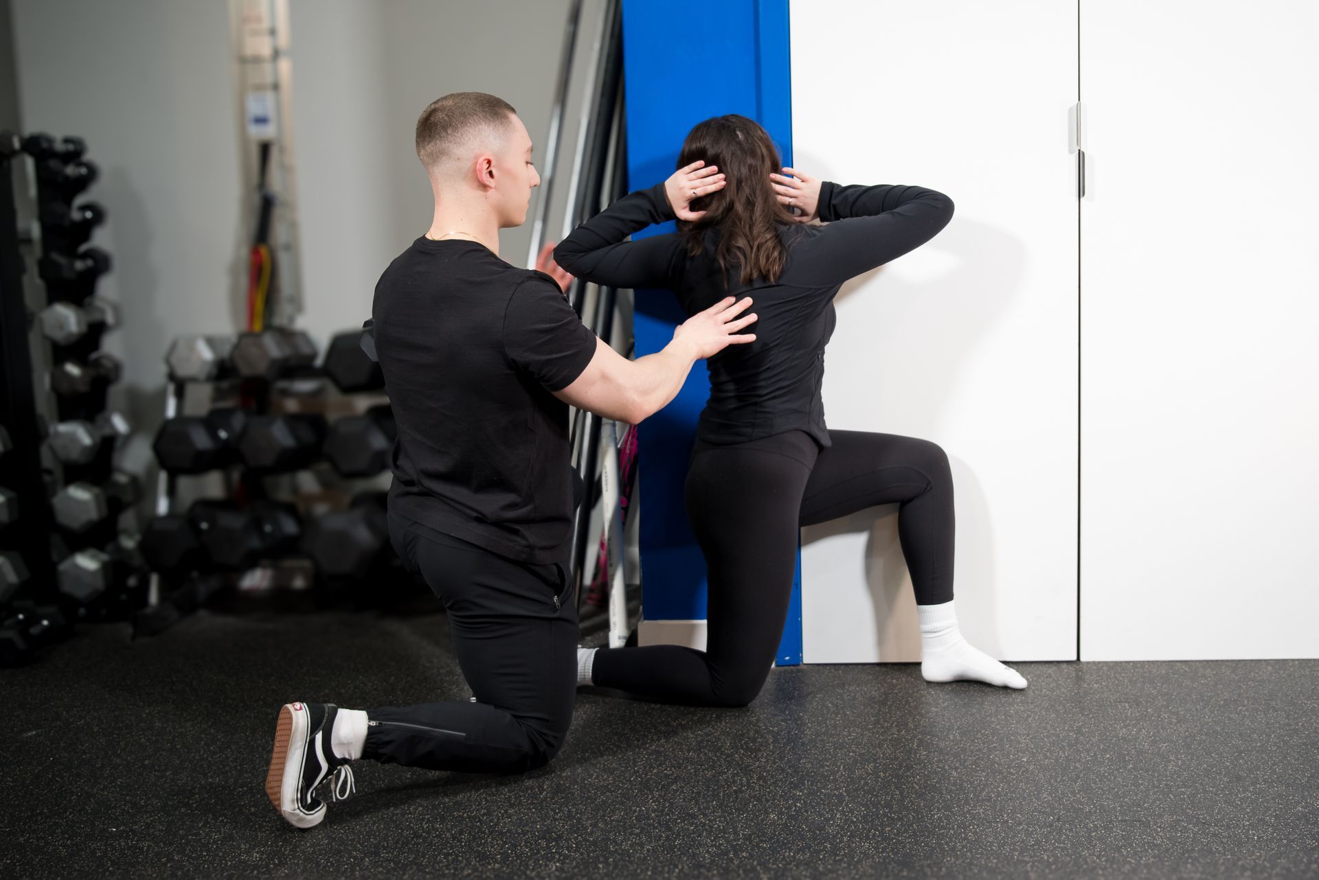 man assisting woman with rotation exercise