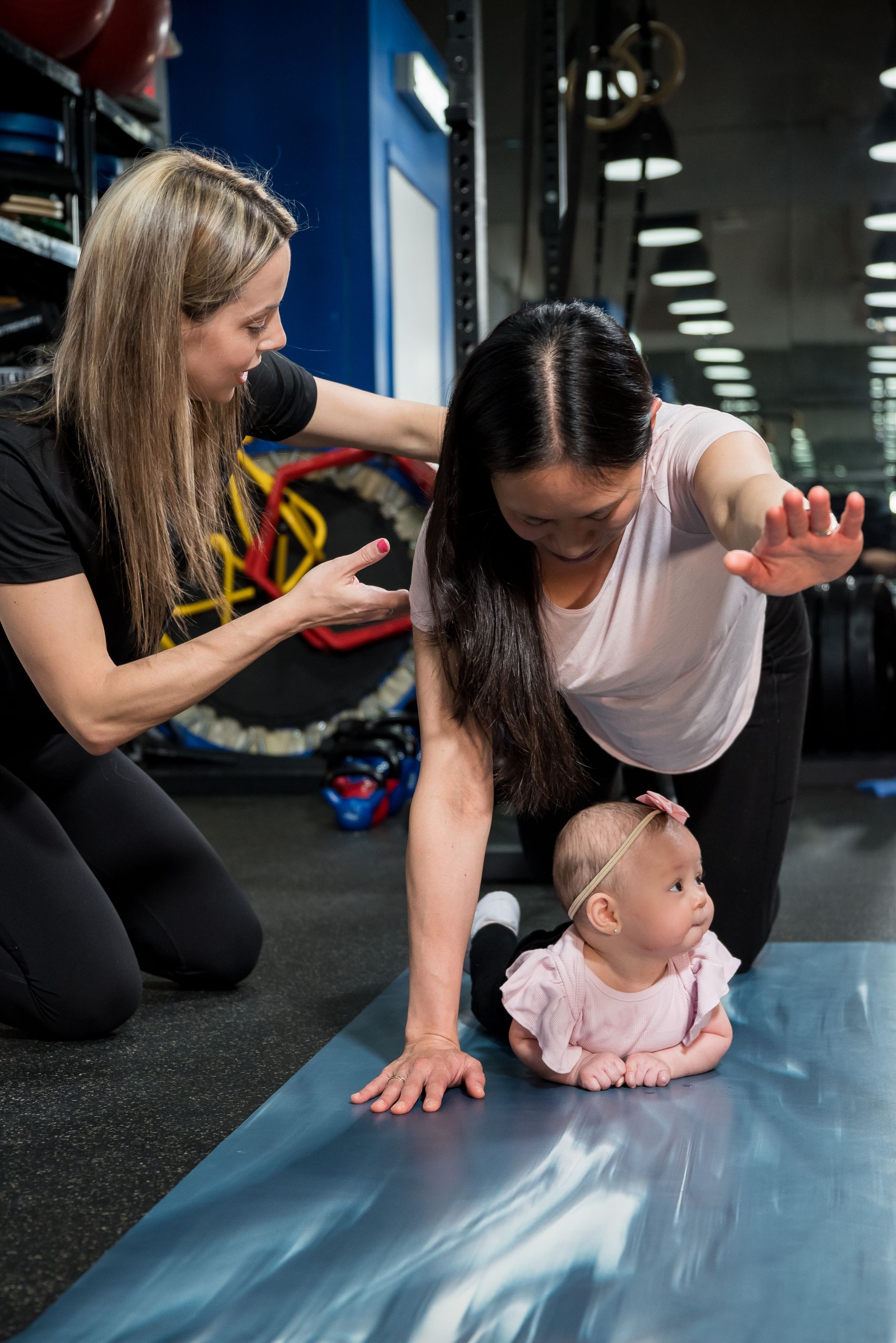 post natal rehab of mom with infant exercising 