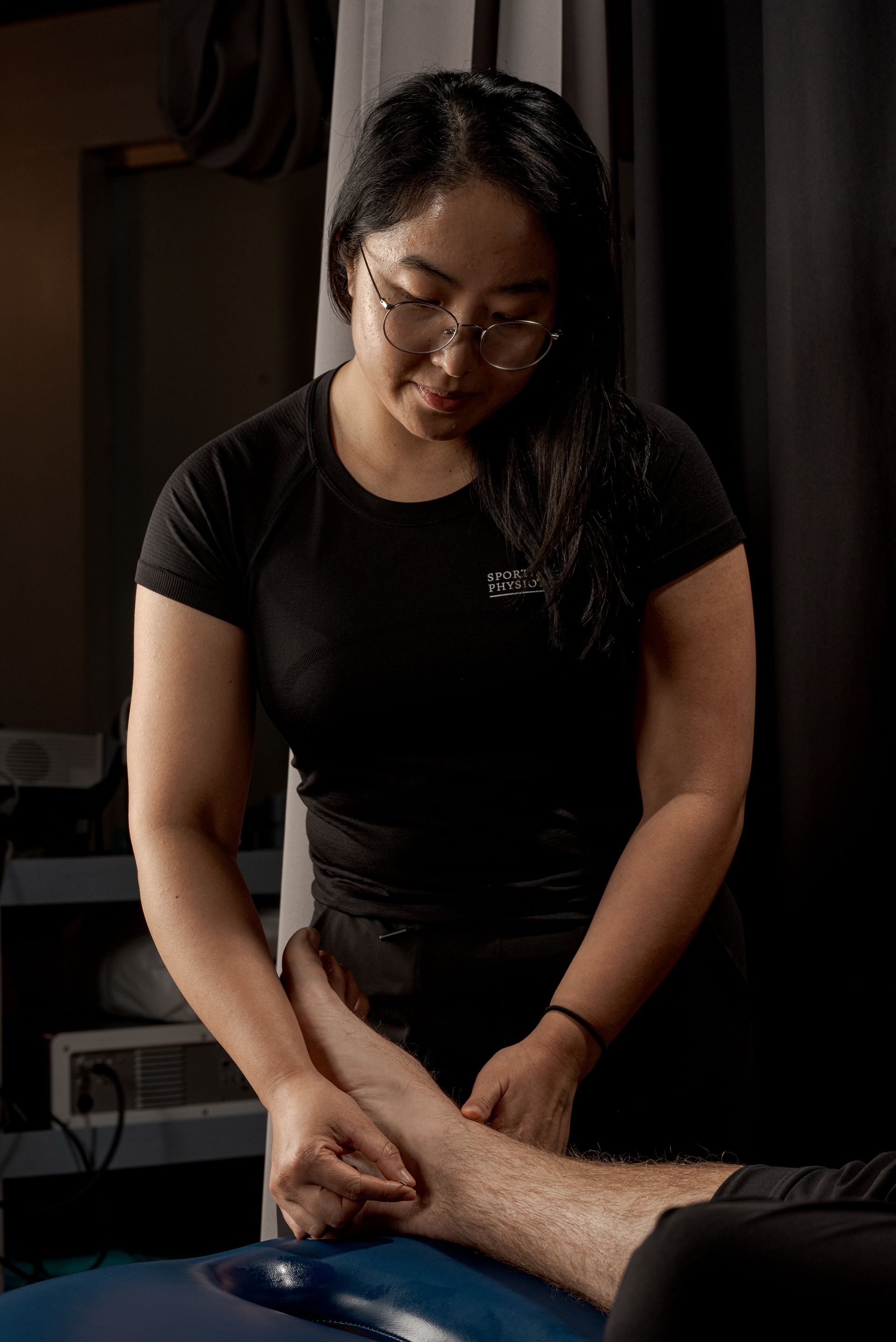 Physio Kathleen Li performing medical acupuncture on achilles tendon