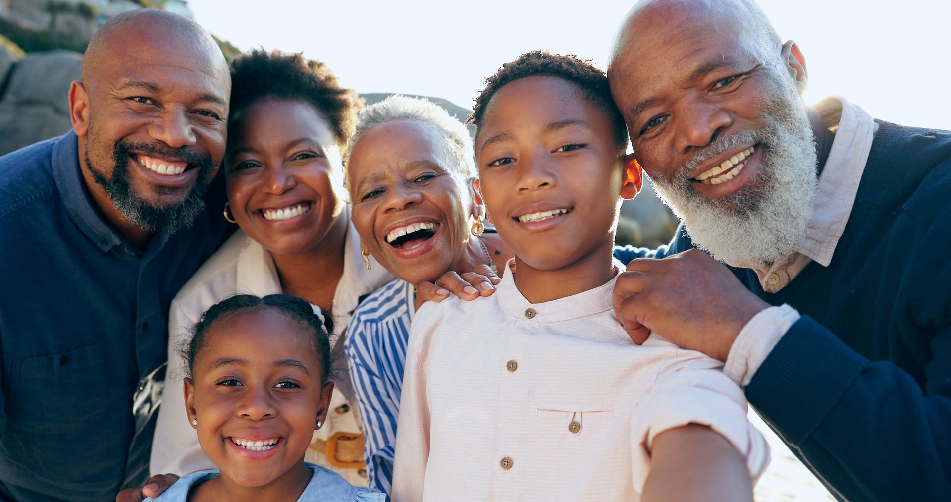 A group of people are posing for a picture together and smiling.