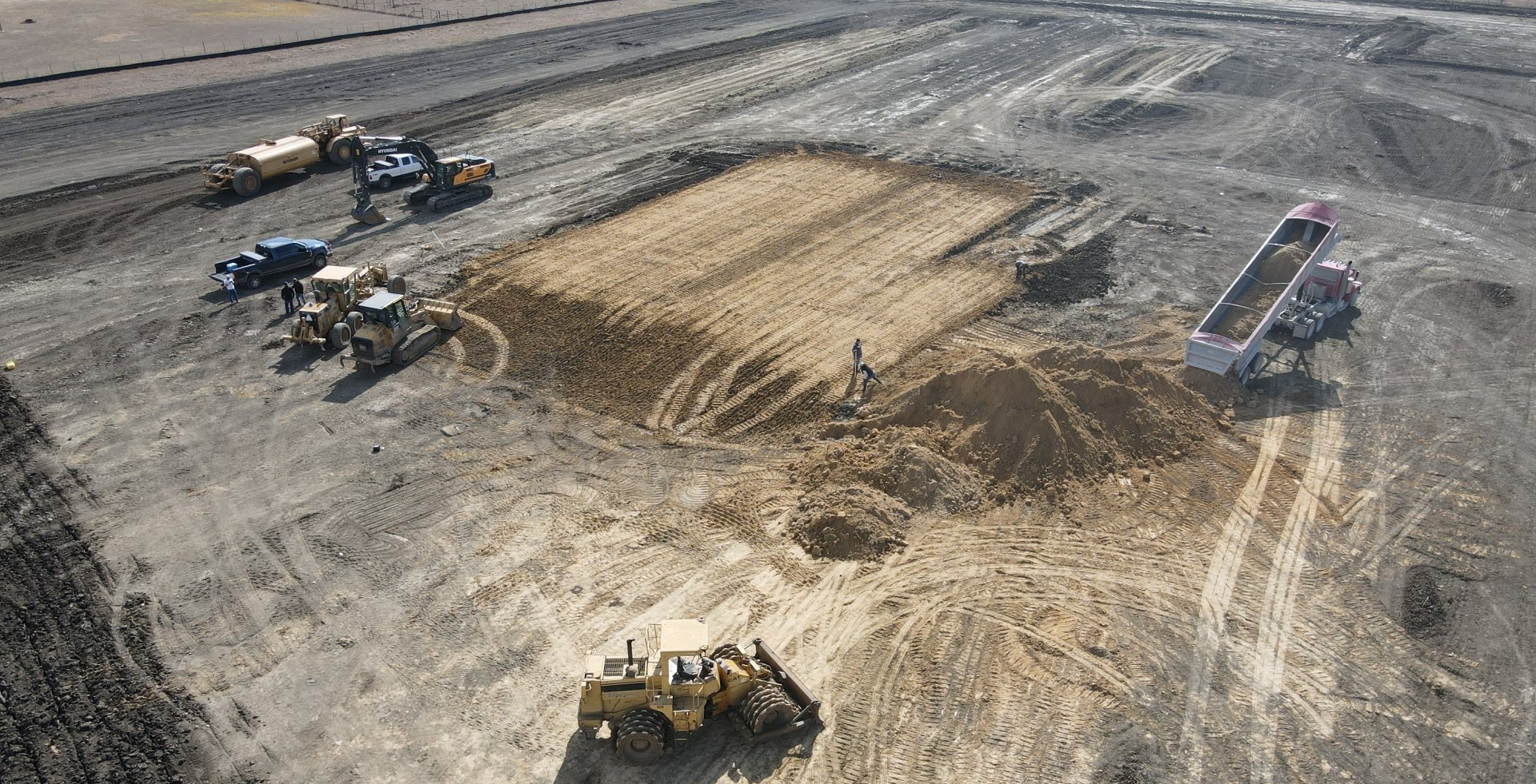 An aerial view of a construction site with a lot of machinery.