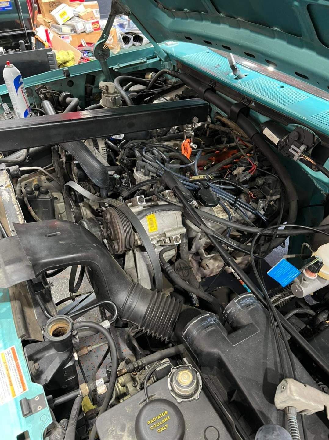 a car engine with a radiator cap that says radiator coolant only | Outlawed Customs
