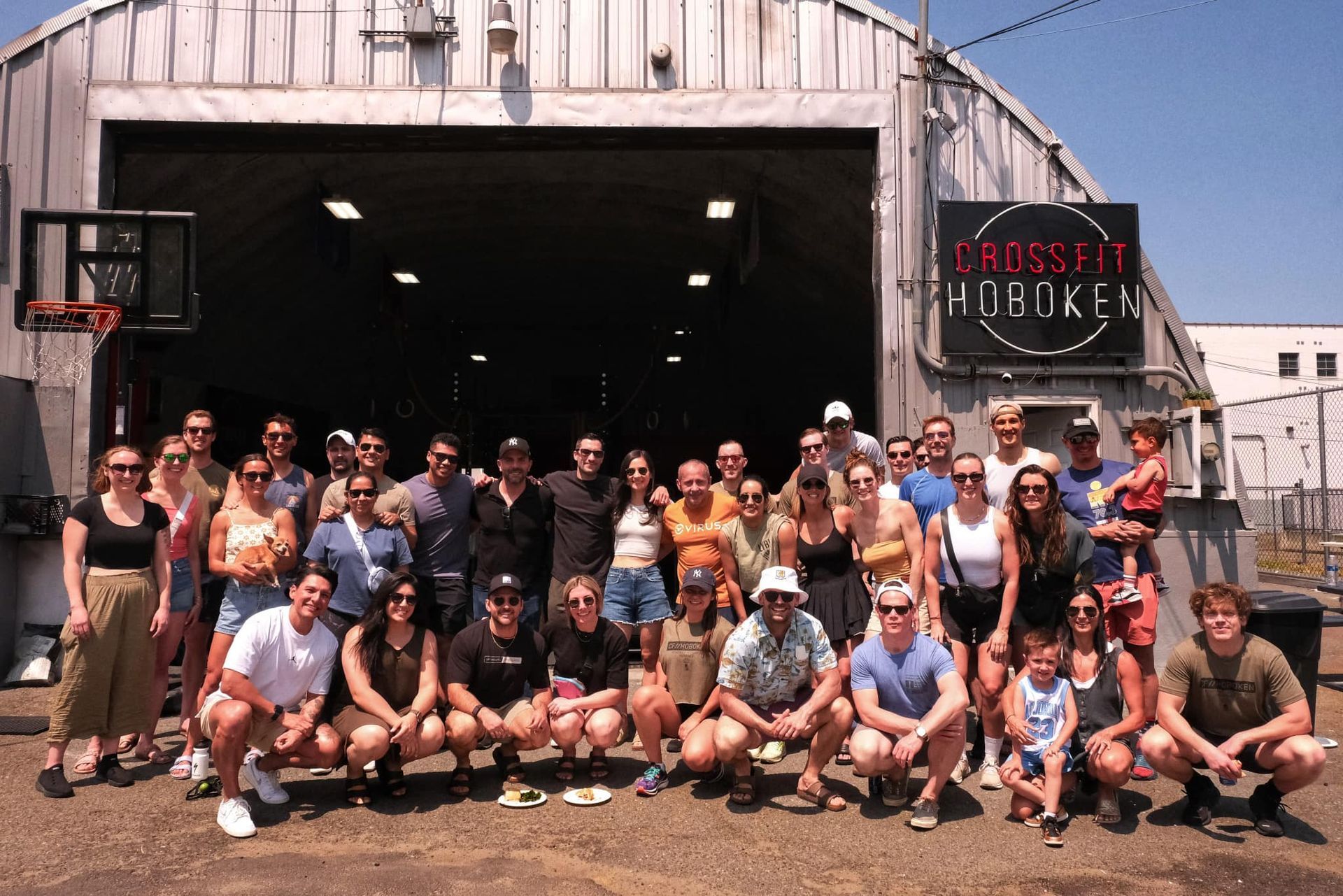 A large group of people are posing for a picture in front of a building.
